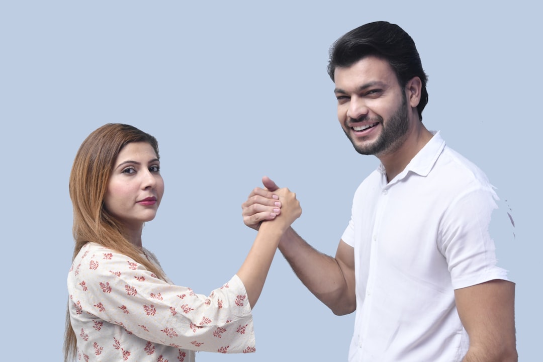 Image depicting a handshake over a property deed