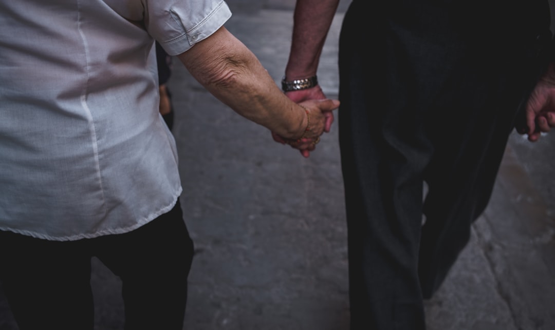 Image of a person shaking hands with another person after signing a car purchase agreement.