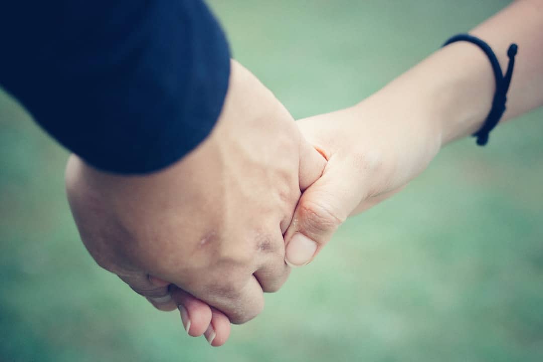 Two people shaking hands after signing a car sales agreement