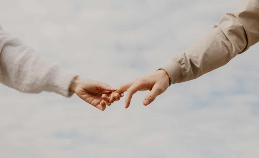 Two people shaking hands after signing a loan agreement.